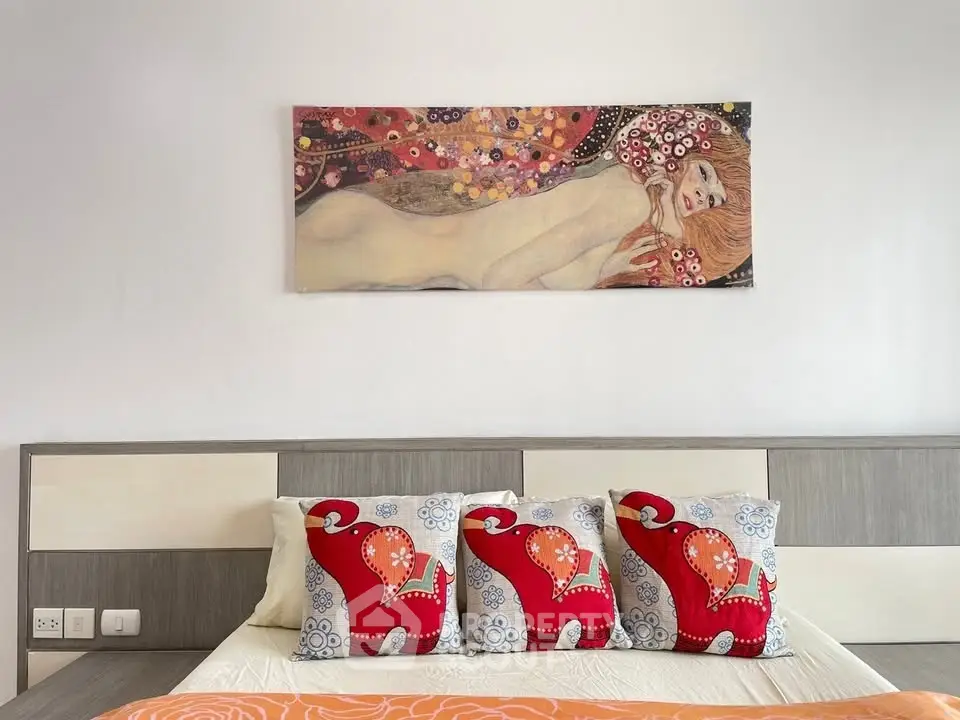 Stylish bedroom with modern art and vibrant cushions