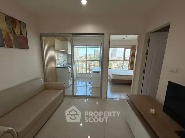 Modern apartment with open living room, kitchen, and bedroom view