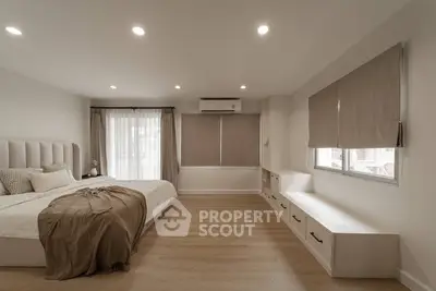 Spacious modern bedroom with elegant decor and natural light