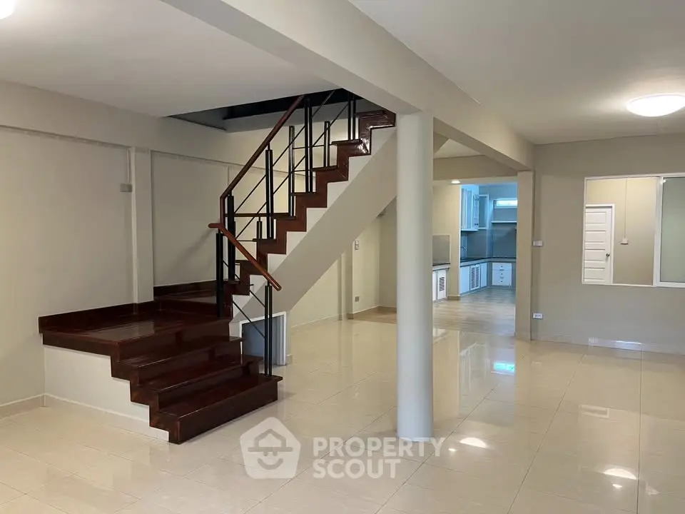 Spacious modern interior with elegant staircase and open kitchen layout