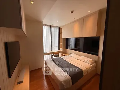 Modern bedroom with sleek design and natural light, featuring built-in storage and cozy ambiance.