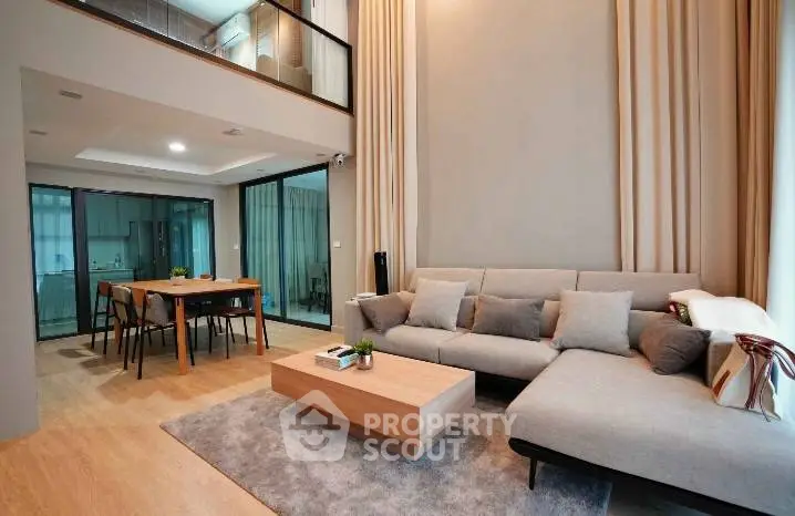 Spacious modern living room with high ceilings and open dining area