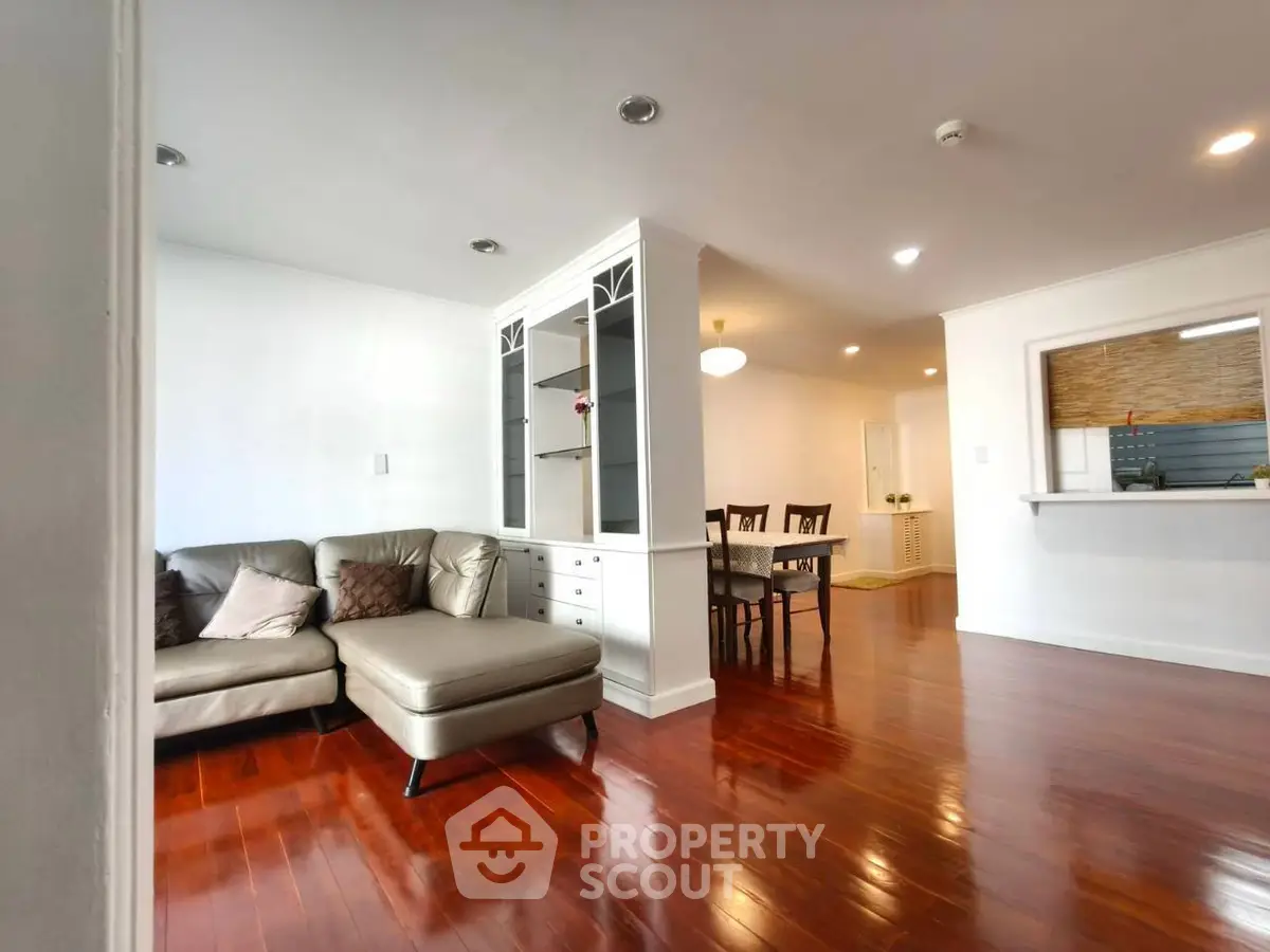 Spacious living room with elegant hardwood floors and cozy seating area