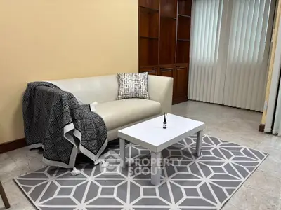 Cozy living room with modern sofa and geometric rug