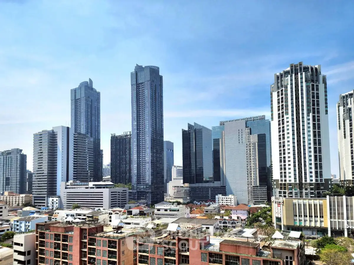 Stunning cityscape view of modern skyscrapers and urban skyline under a clear blue sky.