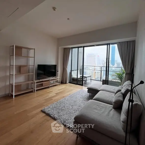 Spacious modern living room with city view and balcony access