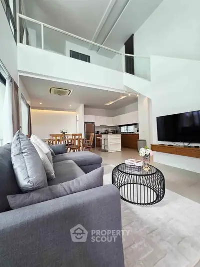 Spacious modern living room with high ceilings and open kitchen layout