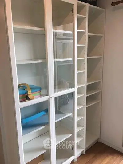 Spacious white shelving unit with glass doors perfect for storage solutions.