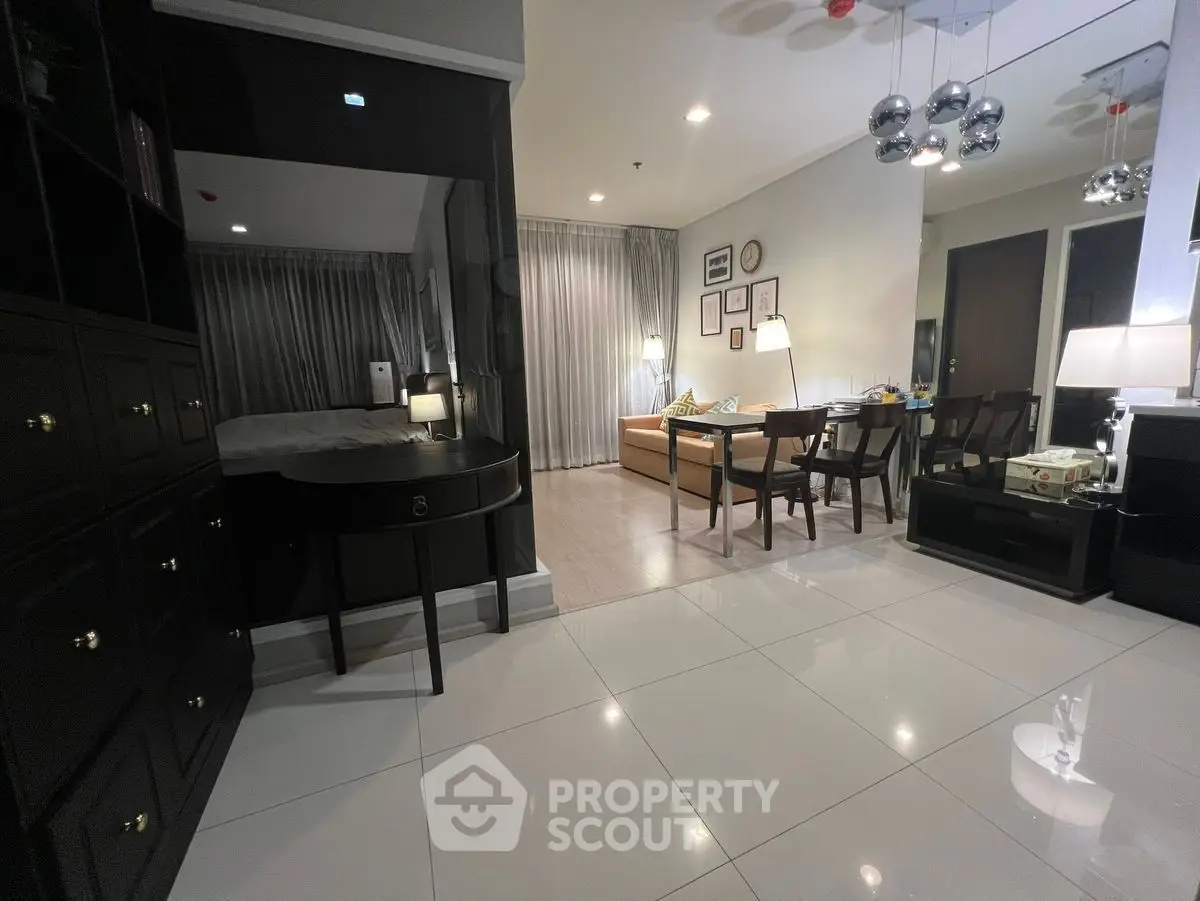 Modern open-plan living and dining area with stylish decor and ample lighting.