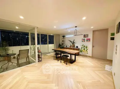 Spacious modern living room with elegant dining area and balcony view