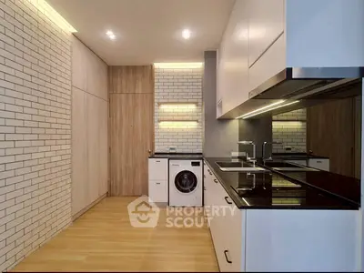 Modern kitchen with sleek cabinetry and built-in washing machine