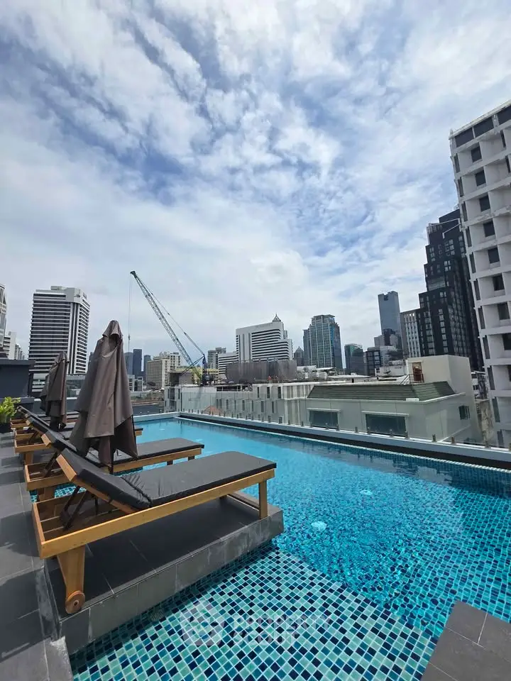 Stunning rooftop pool with city skyline views, perfect for urban living and relaxation.