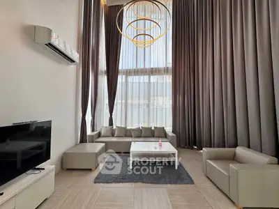 Luxurious high-ceiling living room with modern furniture and elegant lighting