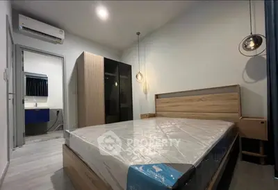 Modern bedroom with sleek design, featuring a comfortable bed, stylish lighting, and a spacious wardrobe.