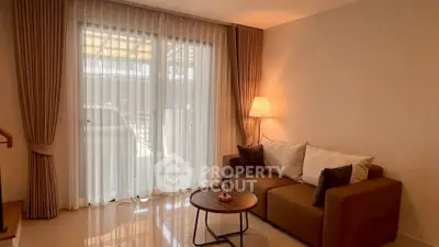 Cozy living room with elegant curtains and modern sofa, perfect for relaxation.