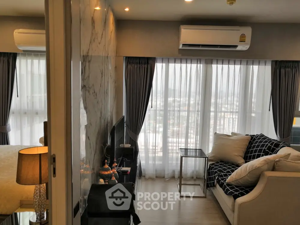 Modern living room with large windows and stylish decor in a high-rise apartment