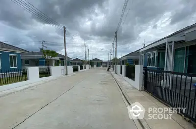 Modern residential street with contemporary houses under cloudy sky