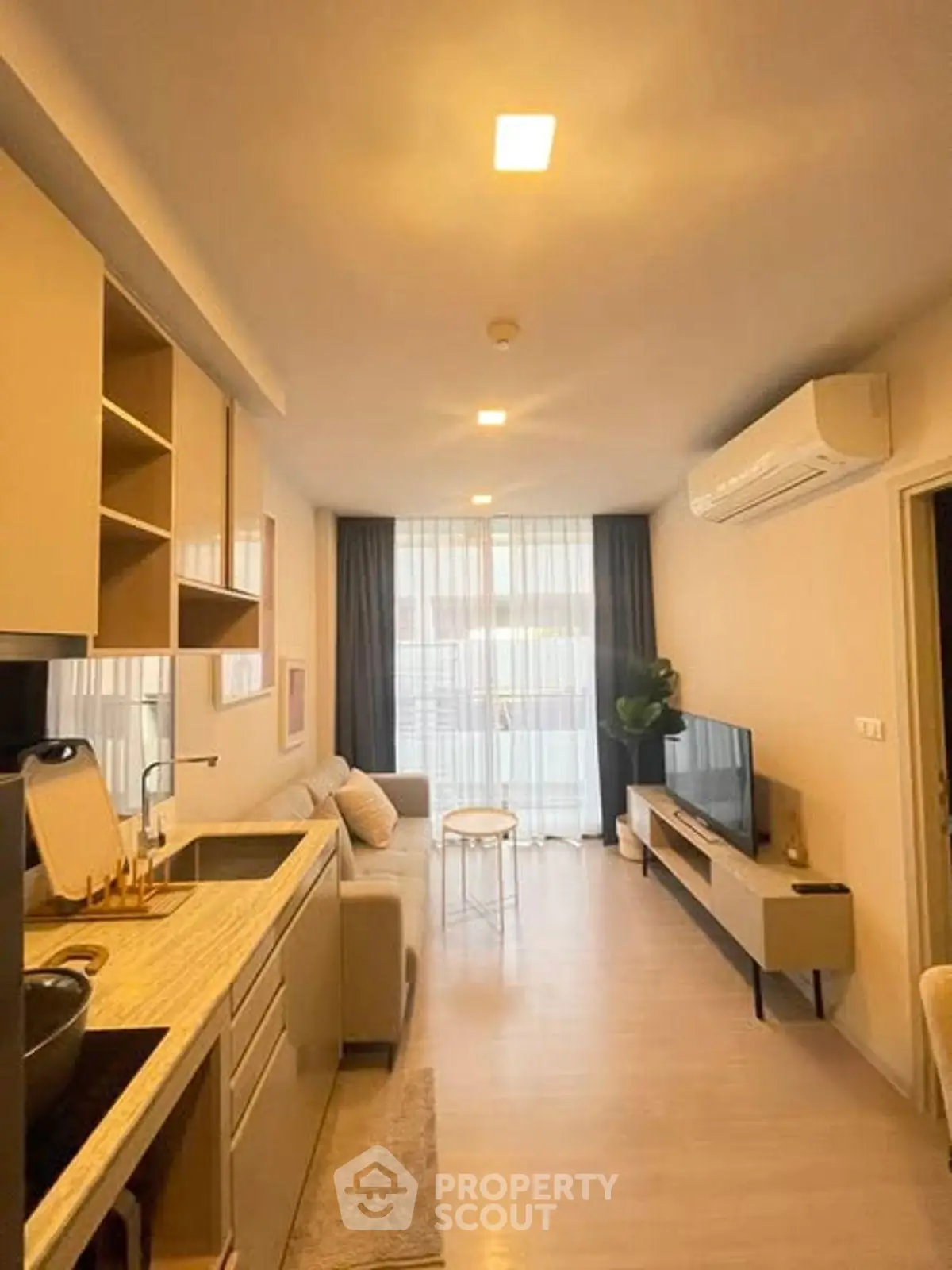 Modern living room with open kitchen and natural light