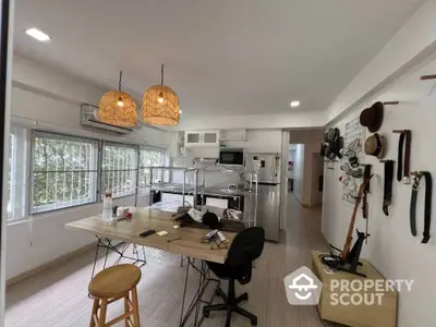 Spacious kitchen with modern appliances and stylish lighting in a cozy home setting.