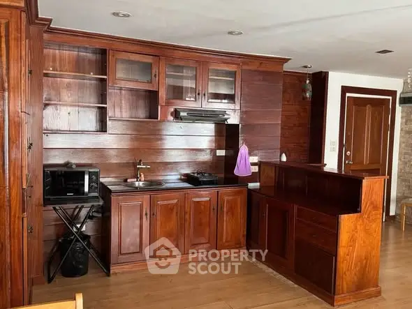 Charming wooden kitchen with closed layout and modern appliances