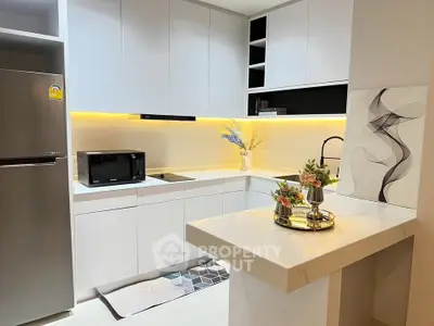 Modern kitchen with sleek white cabinets and stylish lighting