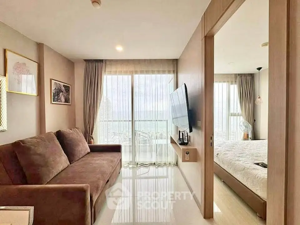Modern apartment living room with large windows and cozy bedroom view