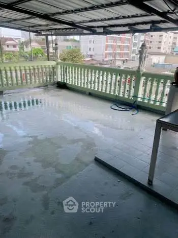 Spacious rooftop terrace with city views and covered area