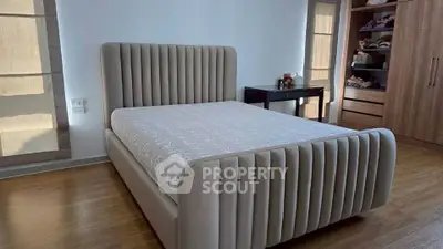 Spacious bedroom with elegant bed and ample closet space, perfect for modern living.