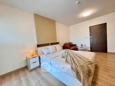 Spacious modern bedroom with cozy decor and wooden flooring