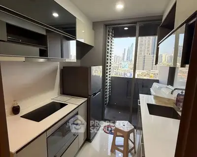 Modern kitchen with sleek design and city view from balcony, featuring built-in appliances and stylish cabinetry.