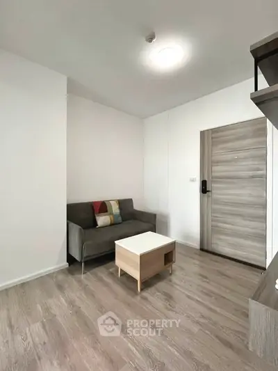 Modern living room with minimalist decor and wooden flooring