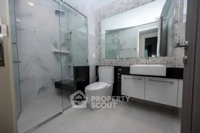 Modern bathroom with glass shower and sleek fixtures