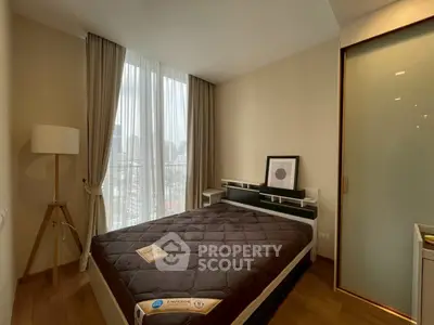 Modern bedroom with city view, featuring a cozy bed, stylish decor, and ample natural light through large windows.