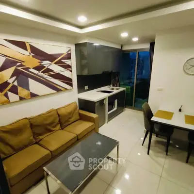 Modern living room with sleek kitchen and stylish decor in a cozy apartment.