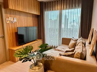 Cozy living room with modern decor and large window offering city view.