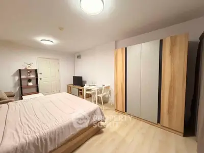 Spacious bedroom with modern furnishings and cozy ambiance, perfect for relaxation and comfort.