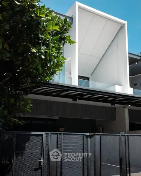 Modern architectural home exterior with sleek design and lush greenery