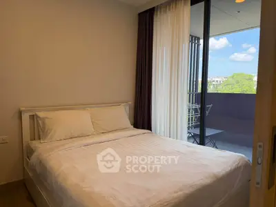 Cozy bedroom with balcony view in modern apartment
