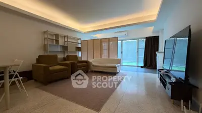 Spacious living room with modern furniture and large TV, perfect for relaxation.