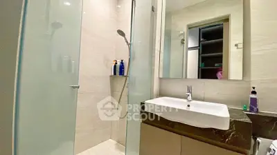 Modern bathroom with glass shower and sleek sink design