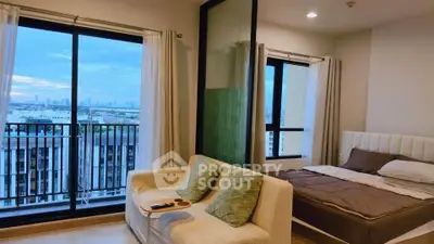 Modern bedroom with balcony and stunning city view in high-rise apartment