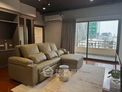 Spacious living room with modern sofa and city view balcony in luxury apartment.