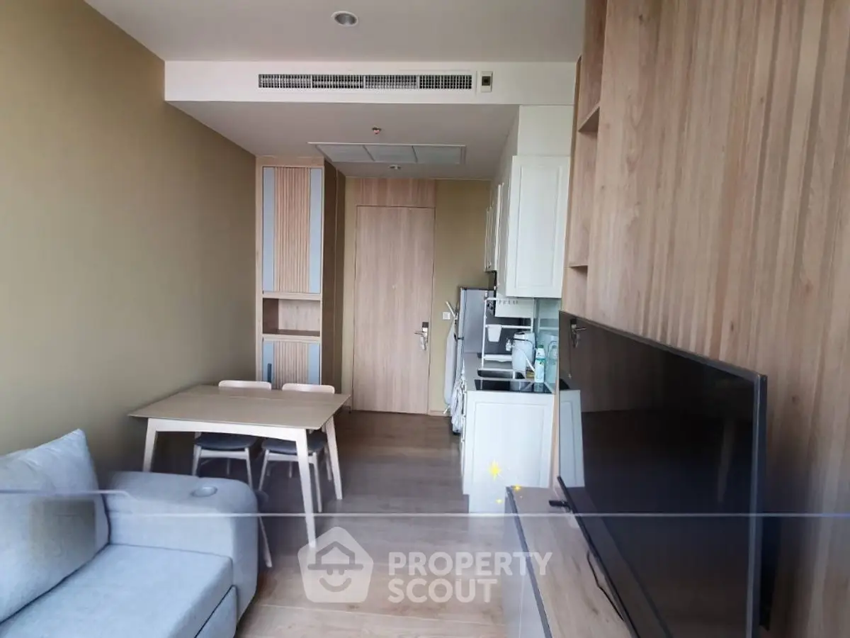 Modern living room with wooden accents and cozy furniture in a stylish apartment.