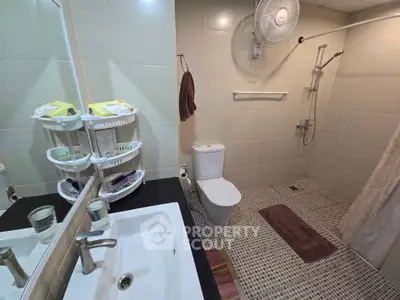 Modern bathroom with sleek fixtures and spacious shower area