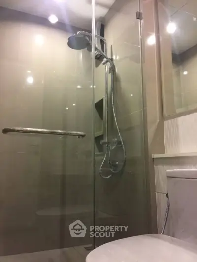 Modern bathroom with glass shower enclosure and sleek fixtures