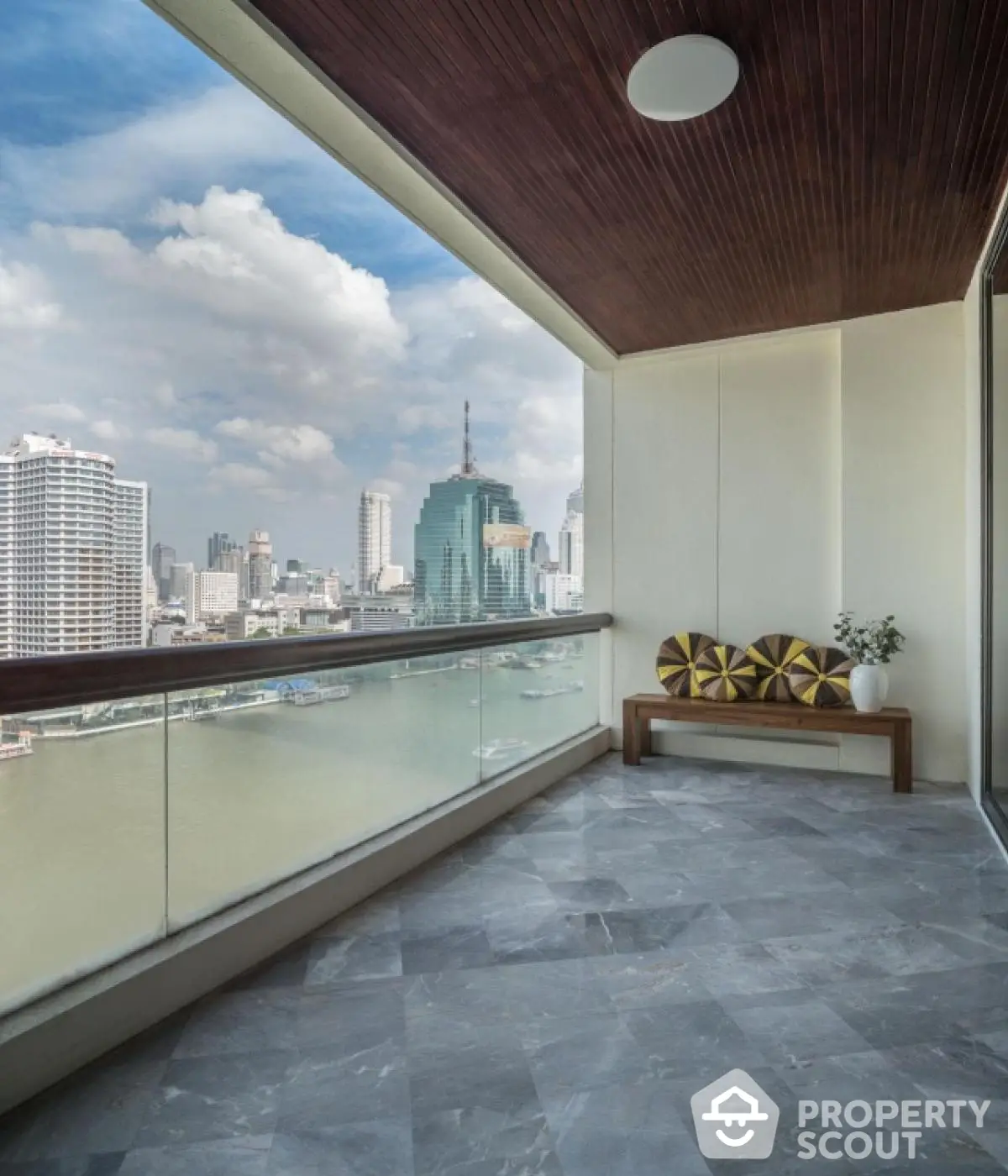 Stunning high-rise balcony with panoramic city and river views, perfect for relaxation and entertainment.