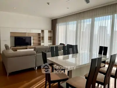 Spacious modern living room with large windows and elegant dining area