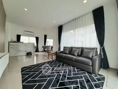 Spacious modern living room with elegant decor and large windows