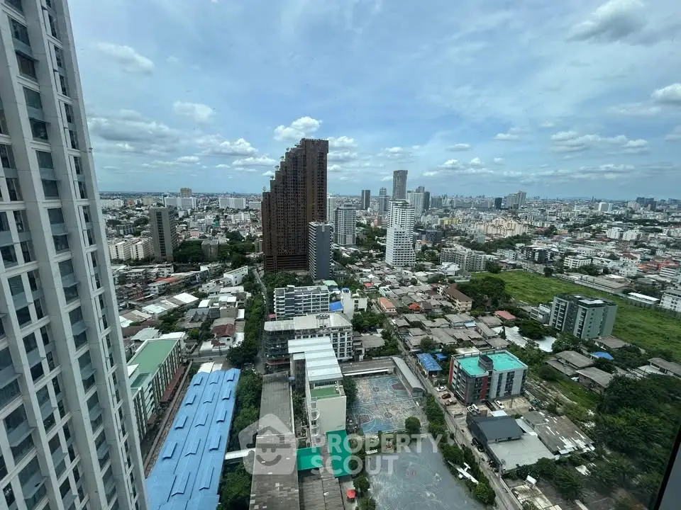Stunning cityscape view from high-rise building showcasing urban skyline and residential areas.