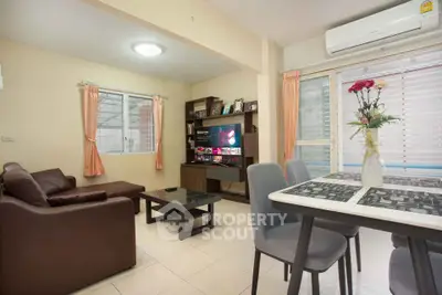 Cozy living room with modern furniture and dining area, perfect for relaxation and entertainment.